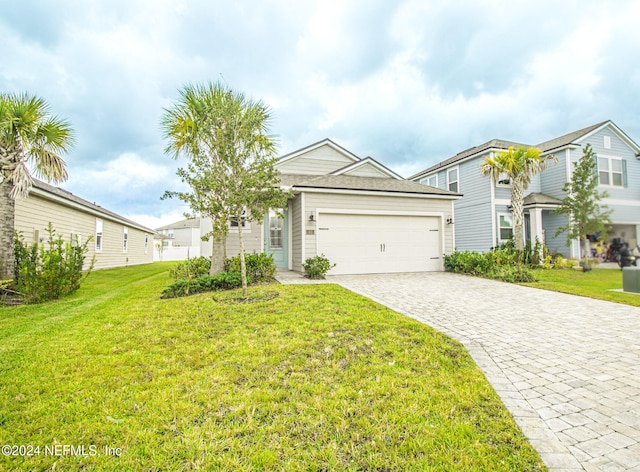 view of front of property with a garage and a front lawn