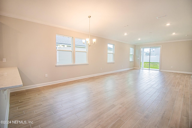 interior space with an inviting chandelier, ornamental molding, and light wood-type flooring