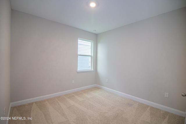 unfurnished room with light carpet