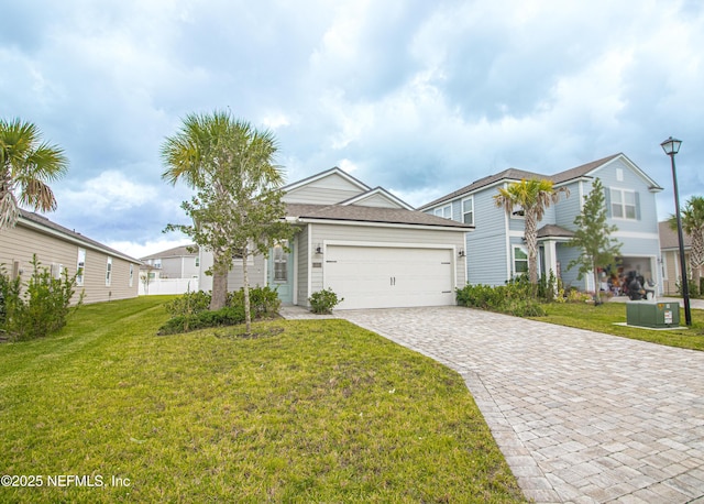 view of front of home with a front yard, a garage, and central AC unit