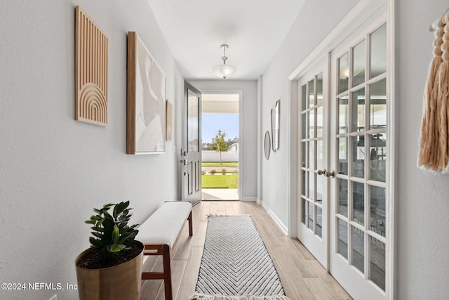 entryway with light hardwood / wood-style flooring and french doors