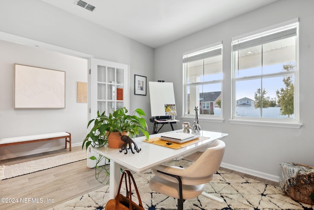 office area with light hardwood / wood-style floors