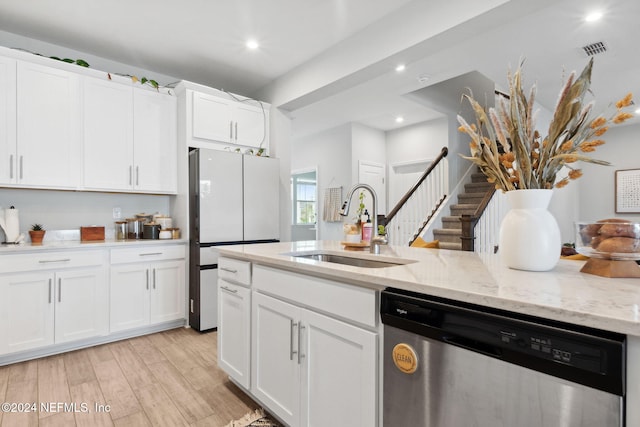 kitchen with white cabinetry, dishwasher, light wood-type flooring, and sink