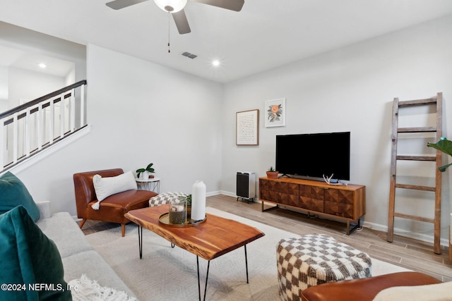 living room featuring light hardwood / wood-style floors and ceiling fan