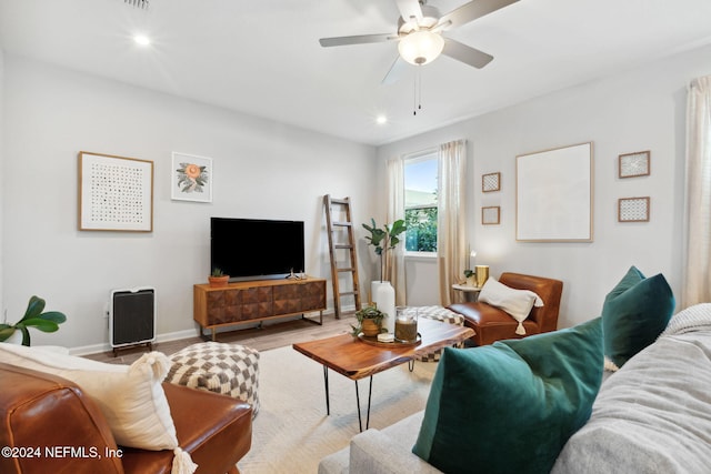 living room featuring ceiling fan and light hardwood / wood-style floors