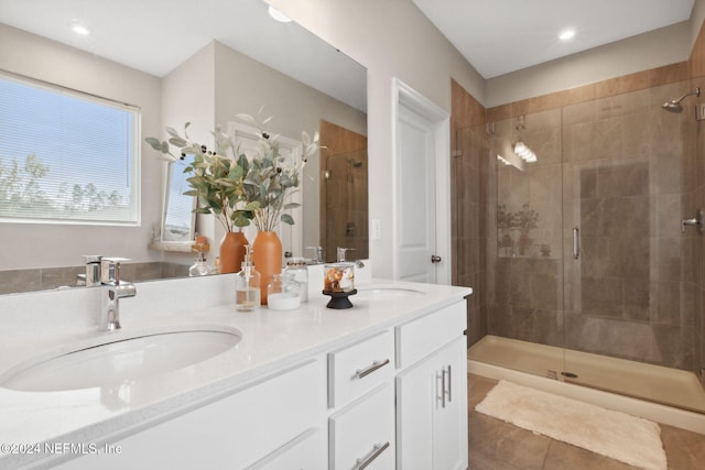 bathroom featuring tile patterned floors, vanity, and walk in shower