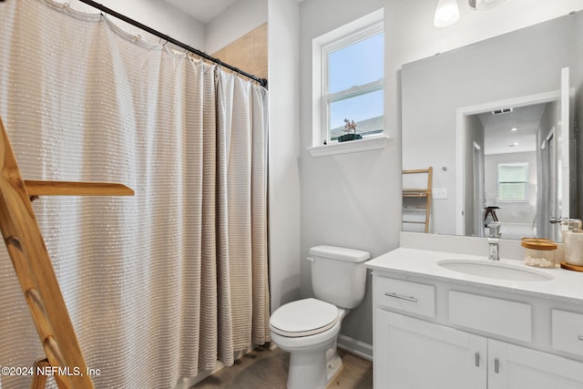 bathroom with vanity, curtained shower, and toilet