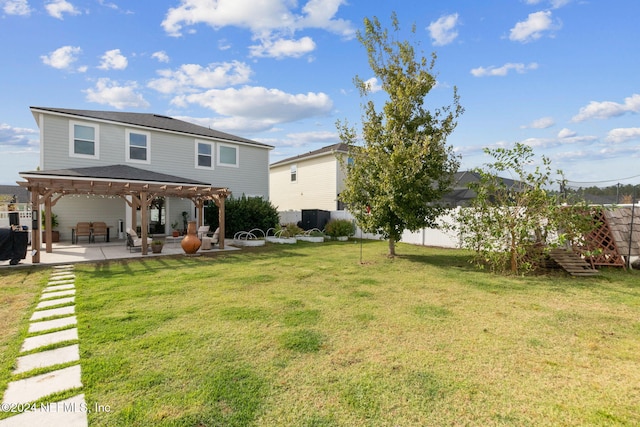 back of house with a pergola, a patio area, and a lawn