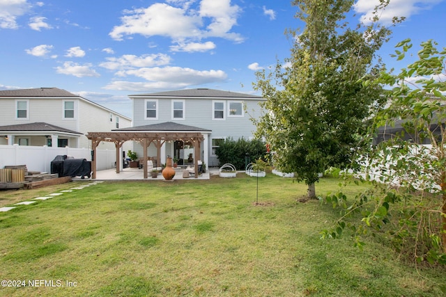 rear view of property featuring a yard, a patio, and a pergola