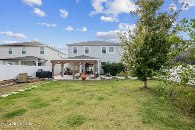 back of house featuring a pergola, a yard, and a patio