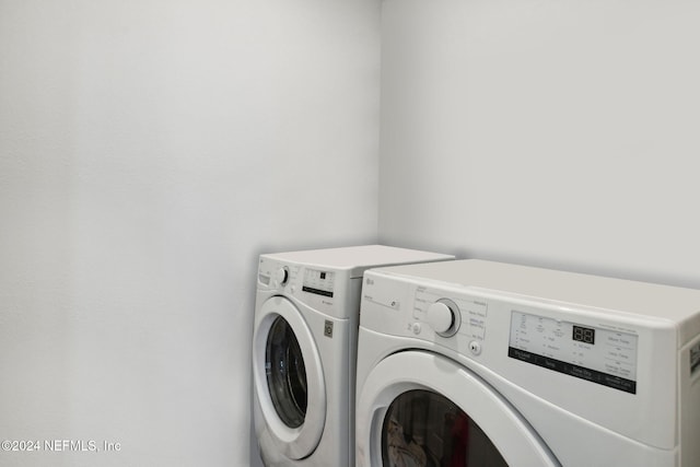 clothes washing area featuring washer and dryer