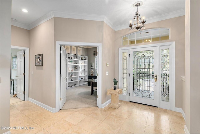 entrance foyer with light colored carpet, ornamental molding, and a notable chandelier