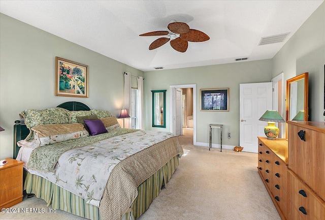 carpeted bedroom featuring ceiling fan and ensuite bathroom