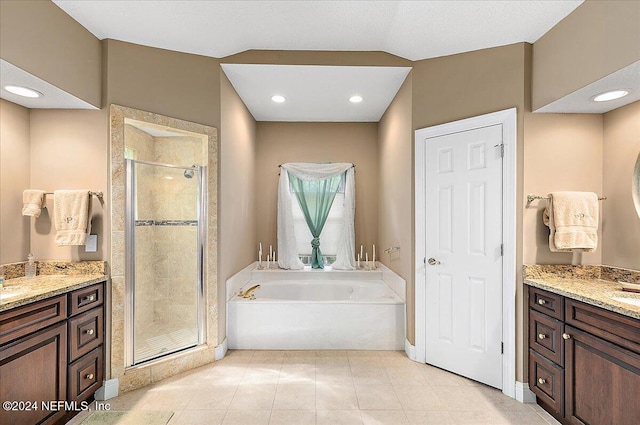 bathroom with tile patterned flooring, vanity, and separate shower and tub