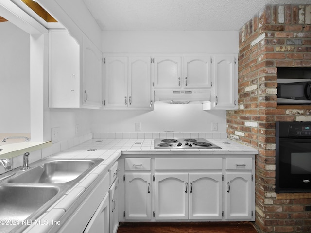 kitchen featuring white cabinetry, black oven, sink, and white electric cooktop