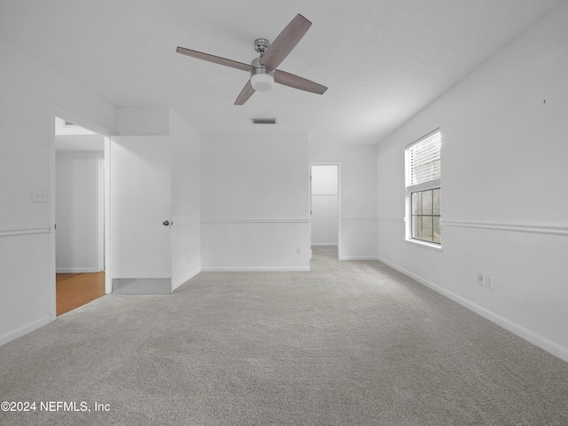 unfurnished room featuring light colored carpet and ceiling fan