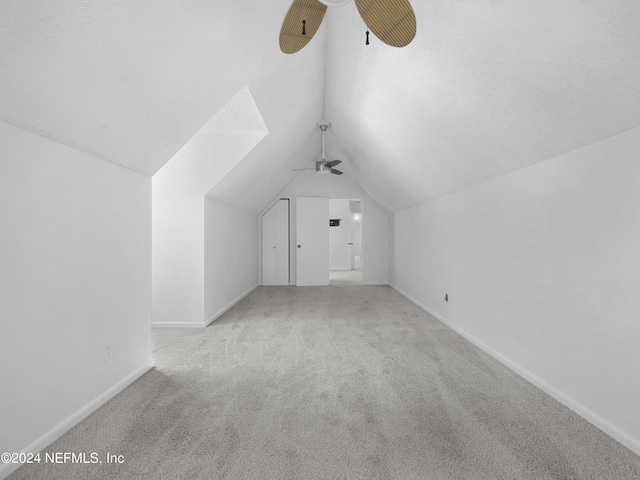 additional living space with lofted ceiling and light colored carpet