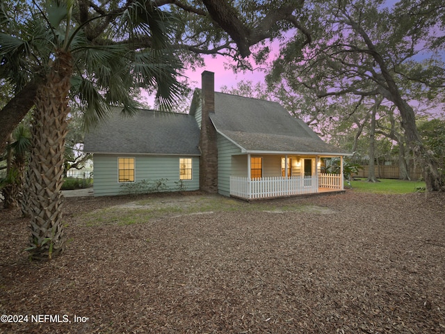 property exterior at dusk with a porch