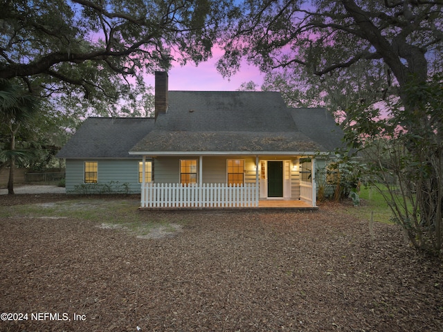 view of back house at dusk