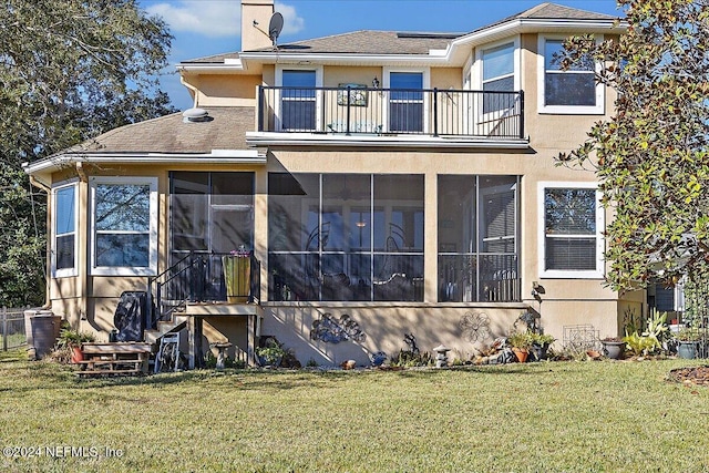 back of property featuring central AC unit, a sunroom, and a yard