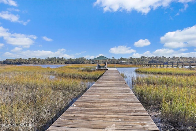 dock area with a gazebo and a water view