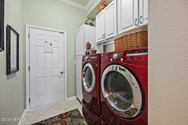 washroom featuring washer and clothes dryer, light tile patterned floors, cabinets, and ornamental molding