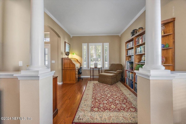 living area with hardwood / wood-style floors and ornamental molding