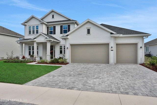 view of front of property featuring a garage and a front lawn