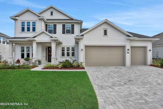 view of front facade with a front yard and a garage