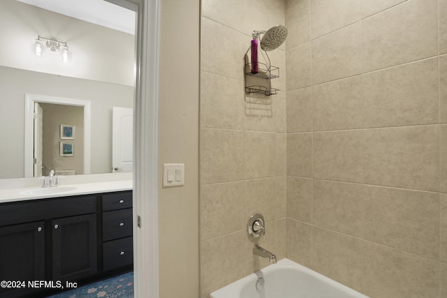 bathroom featuring vanity and tiled shower / bath