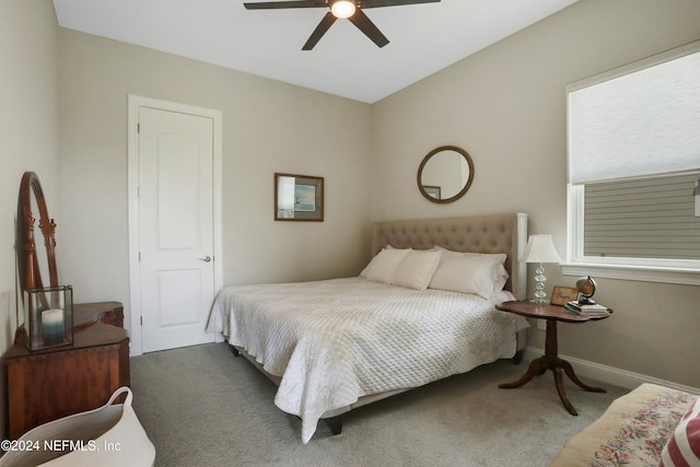 bedroom with ceiling fan and dark carpet