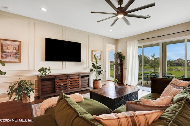 living room featuring hardwood / wood-style floors and ceiling fan