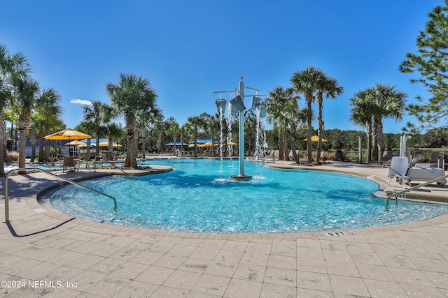 view of pool with pool water feature and a patio