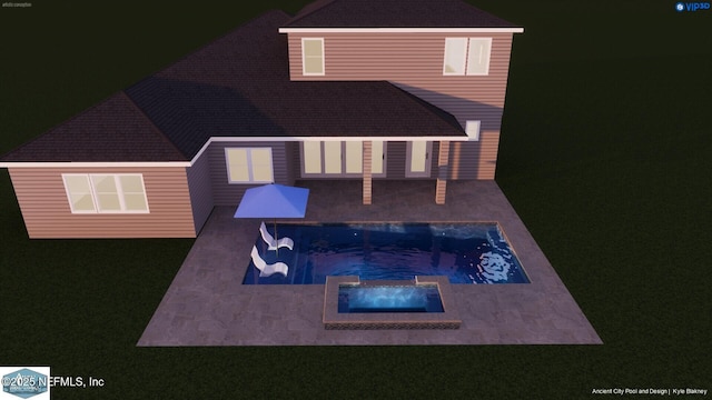 rear view of house featuring an in ground hot tub and a patio