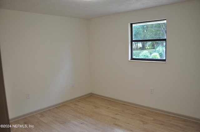 spare room with light hardwood / wood-style flooring