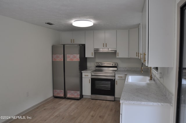 kitchen featuring stainless steel appliances, a textured ceiling, sink, white cabinetry, and light hardwood / wood-style flooring