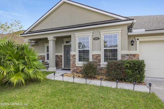 view of front of home with a garage and a front yard