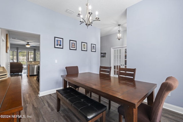 dining space with french doors, dark wood-type flooring, and ceiling fan with notable chandelier