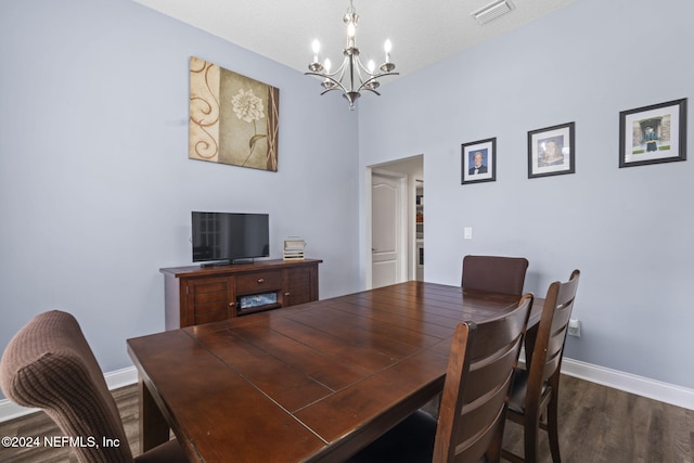 dining area featuring a chandelier and dark hardwood / wood-style flooring