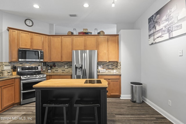 kitchen featuring butcher block countertops, decorative backsplash, dark hardwood / wood-style flooring, and stainless steel appliances