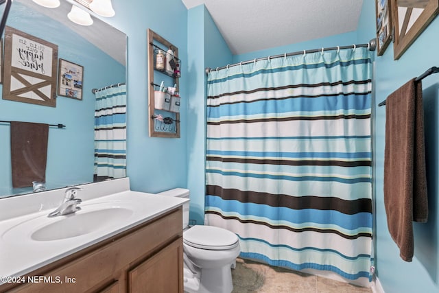 bathroom with a shower with curtain, vanity, a textured ceiling, and toilet