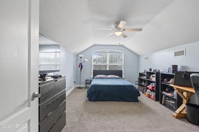 carpeted bedroom featuring a textured ceiling, ceiling fan, and lofted ceiling