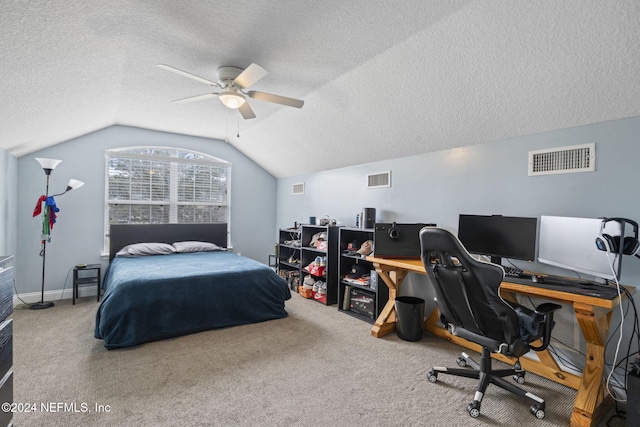 carpeted bedroom featuring a textured ceiling, ceiling fan, and lofted ceiling