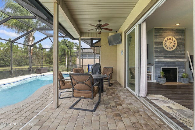 exterior space featuring a fenced in pool, ceiling fan, and a lanai