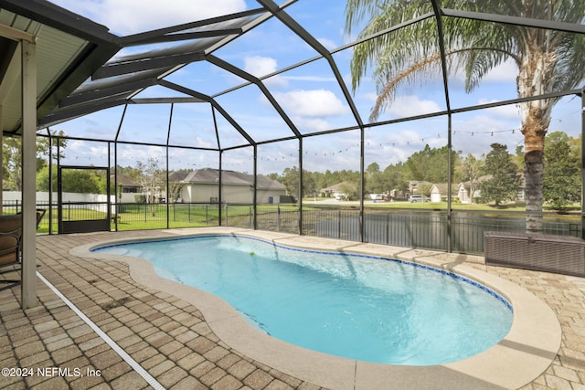 view of pool featuring a patio, a lanai, and a lawn