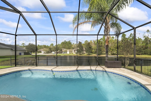 view of swimming pool featuring glass enclosure