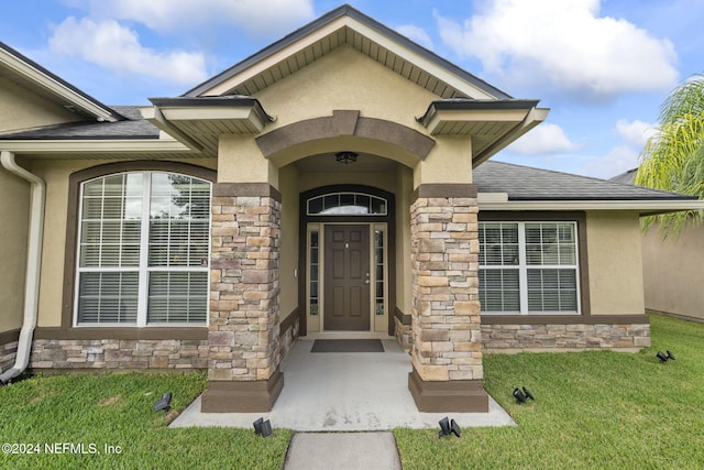 property entrance with a yard