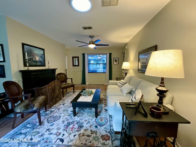 living room featuring ceiling fan and hardwood / wood-style flooring