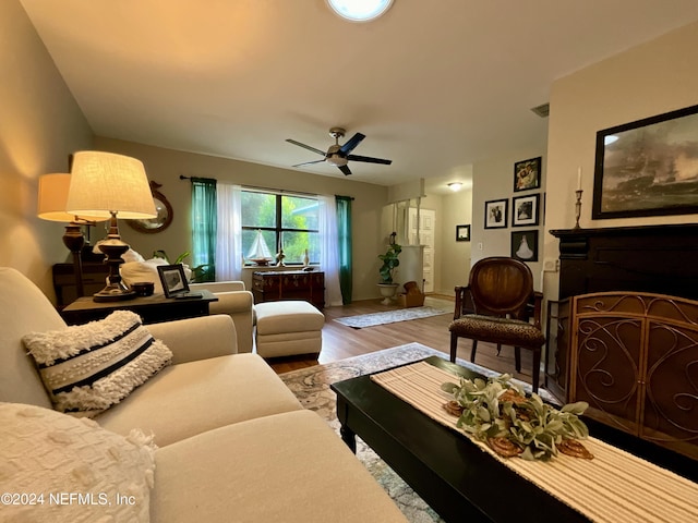 living room with ceiling fan and hardwood / wood-style floors