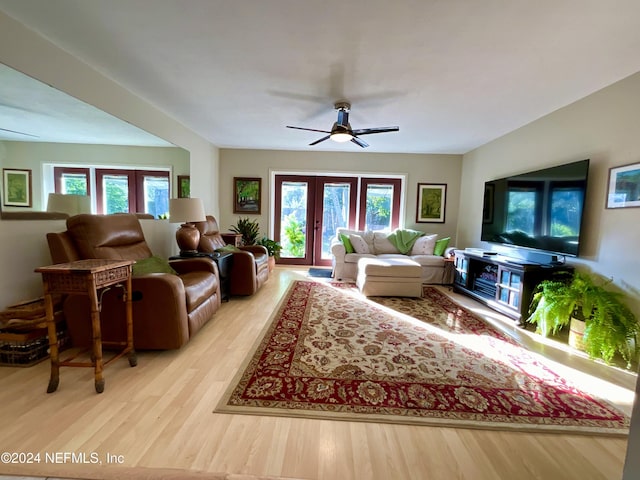 living room with ceiling fan, light hardwood / wood-style floors, and french doors